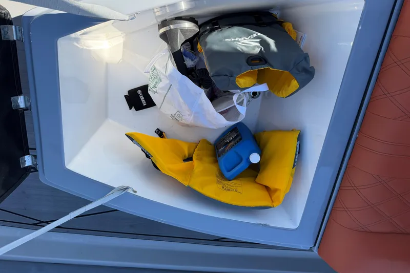 Slide: The Image of Storage compartment of 2023 Fluid Watercraft M35 with life jackets and supplies. - 11