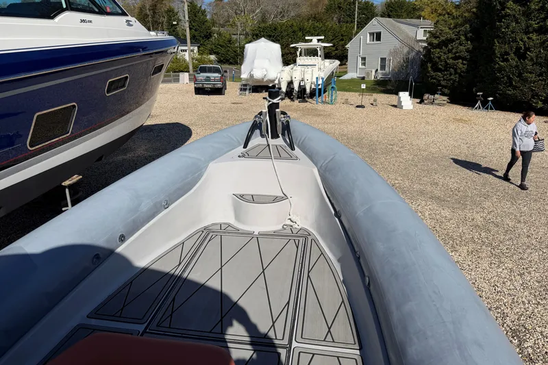 Slide: The Image of 2023 Fluid Watercraft M35 boat on display in a sunny outdoor setting. - 12