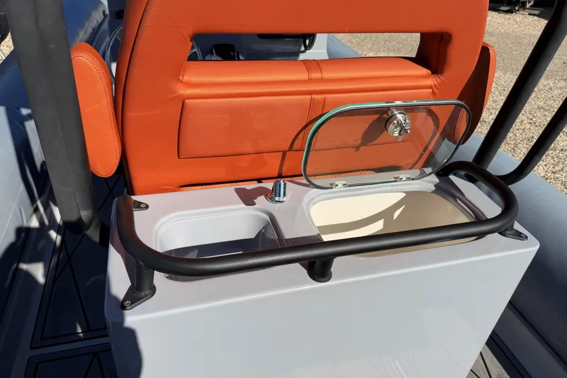 Slide: The Image of 2023 Fluid Watercraft M35 boat interior with orange seating and storage compartment. - 2