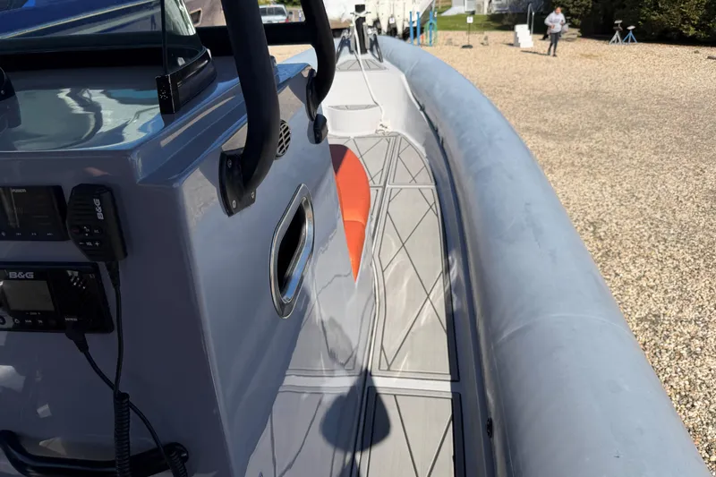 Slide: The Image of 2023 Fluid Watercraft M35 boat deck with control panel and safety equipment. - 7