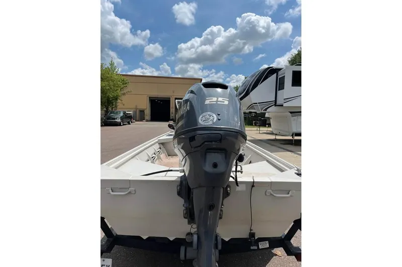 Slide: The Image of 2011 Sea-Ark Rebel 15 boat with Yamaha 25 outboard motor, parked outdoors. - 11