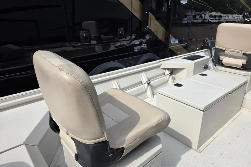 Slide: The Image of 2011 Sea-Ark Rebel 15 boat interior with beige seating and storage compartments. - 4