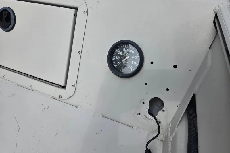 Slide: The Image of 2011 Sea-Ark Rebel 15 dashboard with RPM gauge and storage compartment. - 7