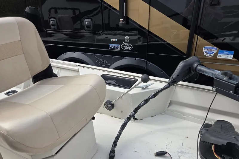 Slide: The Image of 2011 Sea-Ark Rebel 15 boat interior with beige seating and control panel. - 8
