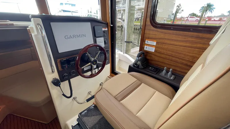 Slide: The Image of 2023 Ranger Tugs R-31 CB helm with Garmin display and leather seating. - 14