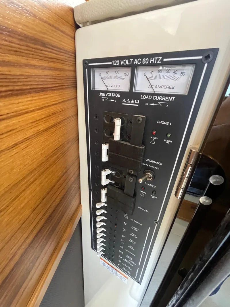 Slide: The Image of Electrical panel of 2023 Ranger Tugs R-31 CB boat, showing voltage and current controls. - 26