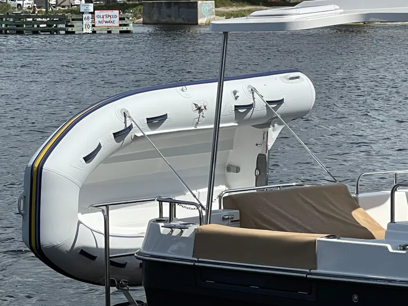 Slide: The Image of 2023 Ranger Tugs R-31 CB with inflatable dinghy on water. - 7