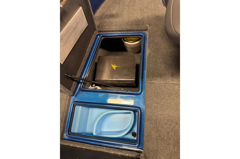 Slide: The Image of Storage compartment in a 2026 Nitro ZV19 Sport boat, featuring a blue interior. - 11