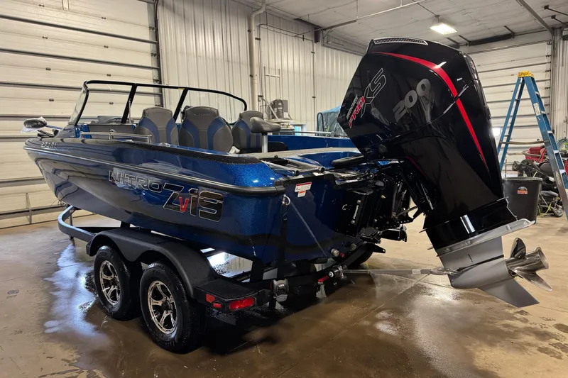 Slide: The Image of 2026 Nitro ZV19 Sport boat with powerful engine in a garage setting. - 2