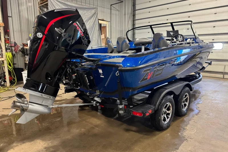 Slide: The Image of 2026 Nitro ZV19 Sport boat with powerful outboard motor in a garage setting. - 3