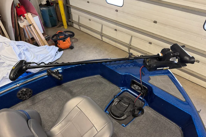 Slide: The Image of 2026 Nitro ZV19 Sport boat with Minn Kota trolling motor in garage. - 9