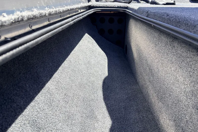 Slide: The Image of Interior storage compartment of 2026 Tracker Pro Team 175 boat, carpeted and spacious. - 14