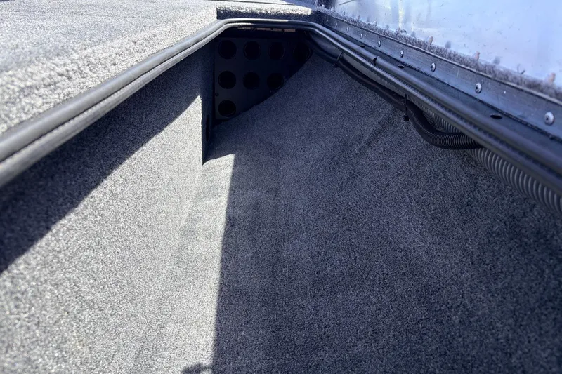 Slide: The Image of Interior view of 2026 Tracker Pro Team 175 boat storage compartment. - 18