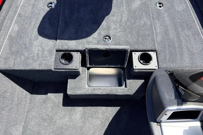Slide: The Image of 2026 Tracker Pro Team 175 boat interior with cup holders and storage compartment. - 19