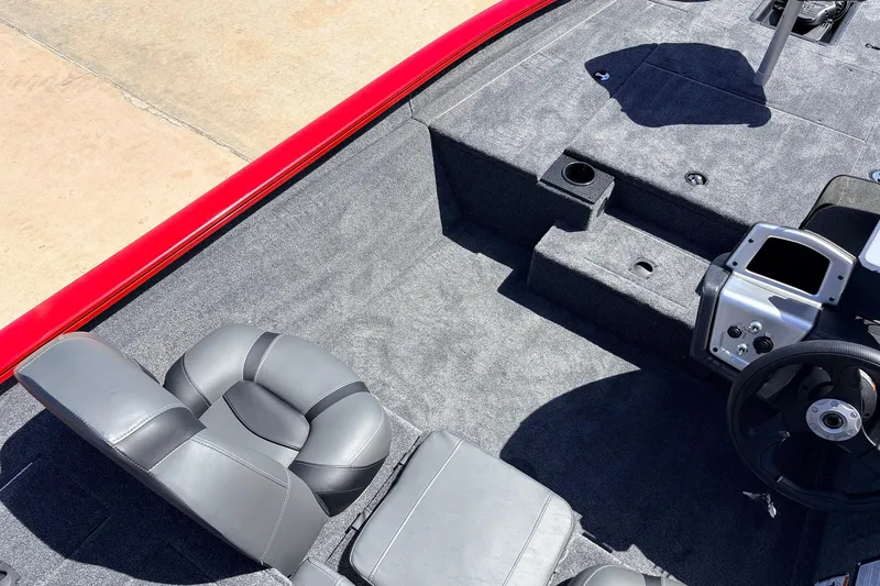Slide: The Image of Interior of 2026 Tracker Pro Team 175 boat with gray seating and steering wheel. - 21