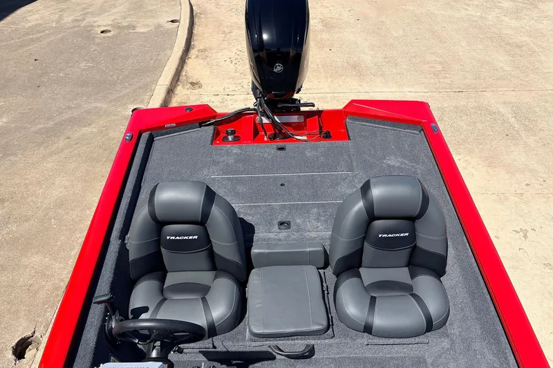 Slide: The Image of 2026 Tracker Pro Team 175 boat interior with two gray seats and red accents. - 28