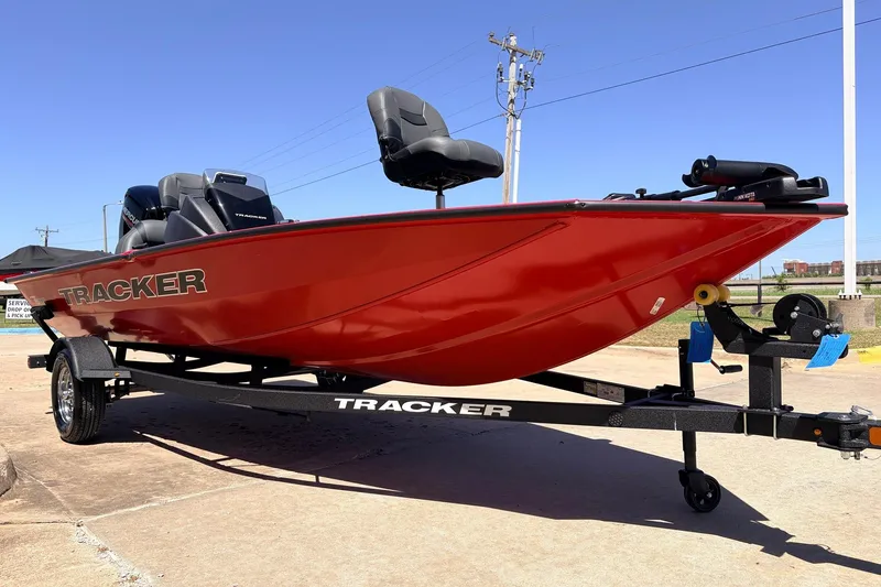 Slide: The Image of Red 2026 Tracker Pro Team 175 boat on trailer, parked outdoors under clear blue sky. - 3