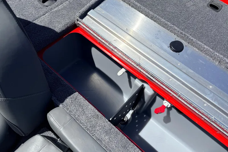 Slide: The Image of 2026 Tracker Pro Team 175 boat storage compartment with gray and red interior. - 30