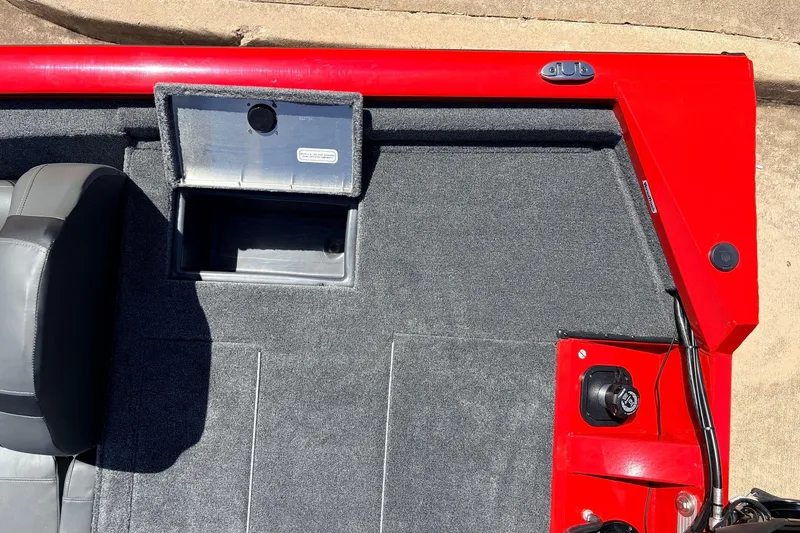 Slide: The Image of 2026 Tracker Pro Team 175 boat interior with red accents and storage compartment. - 34
