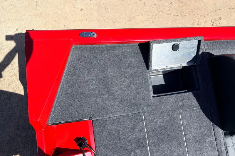 Slide: The Image of 2026 Tracker Pro Team 175 boat interior with red trim and open storage compartment. - 37