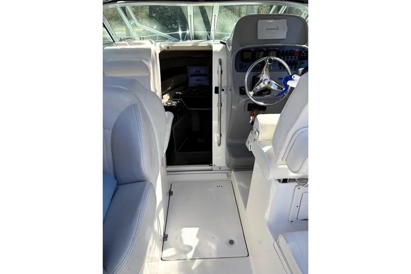 Slide: The Image of 2014 Robalo R265 Walkaround boat interior with helm and seating area. - 11