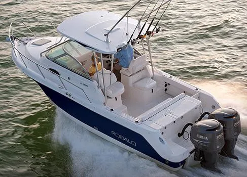 Slide: The Image of Manufacturer Provided Image: 2014 Robalo R265 Walkaround boat cruising on water with dual Yamaha engines. - 14