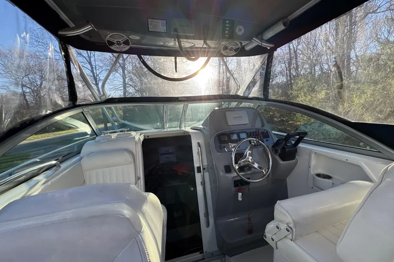 Slide: The Image of 2014 Robalo R265 Walkaround boat interior with steering wheel and seating. - 7