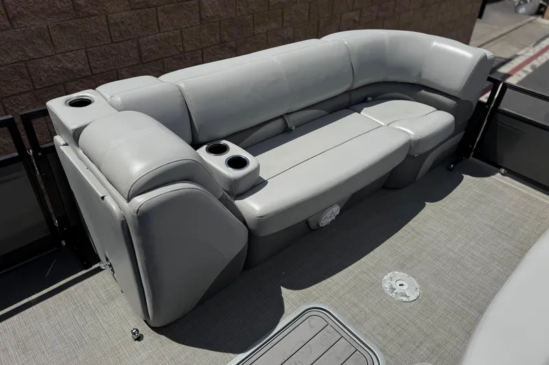 Slide: The Image of 2024 Regency 230 DL3 boat interior with gray seating and cup holders. - 12