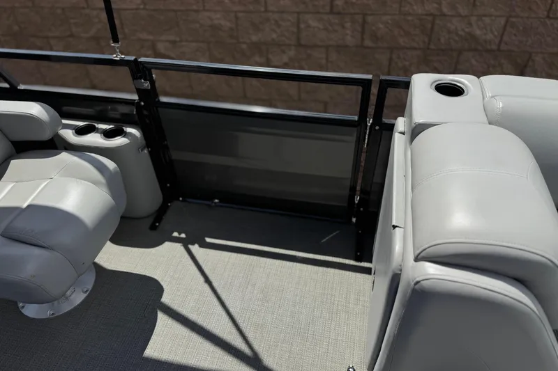 Slide: The Image of 2024 Regency 230 DL3 boat interior with gray seating and cup holders. - 17