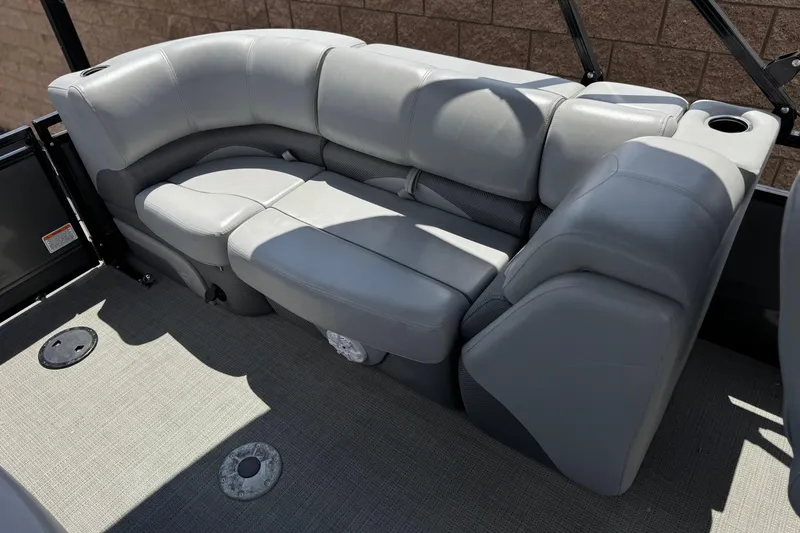 Slide: The Image of 2024 Regency 230 DL3 boat interior with gray cushioned seating and cup holders. - 20