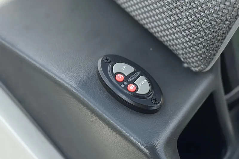 Slide: The Image of Close-up of 2024 Regency 230 DL3 control panel with up and down buttons. - 28