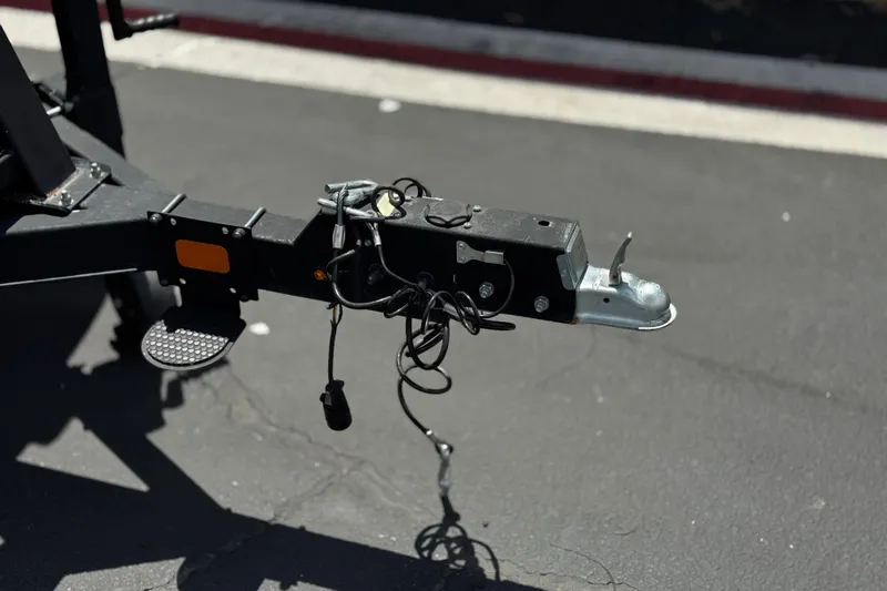 Slide: The Image of Trailer hitch of a 2024 Regency 230 DL3 on asphalt pavement. - 31