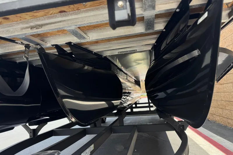 Slide: The Image of Underneath view of a 2024 Regency 230 DL3 boat on a trailer. - 4