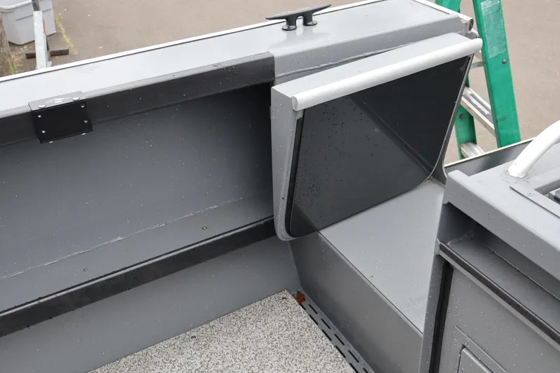 Slide: The Image of 2026 Alumaweld Horizon 24 boat interior detail with storage compartment and gray finish. - 13