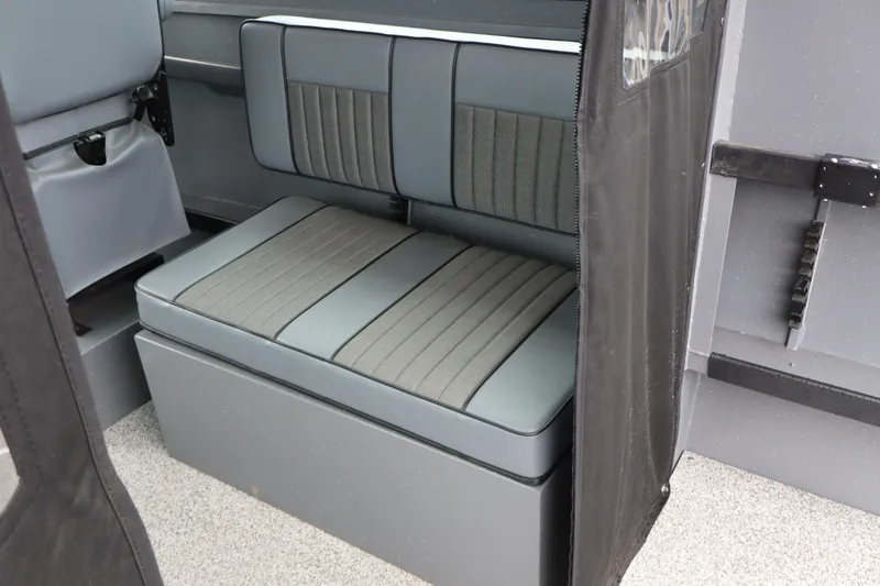 Slide: The Image of 2026 Alumaweld Horizon 24 interior seating with gray upholstery and storage compartment. - 15