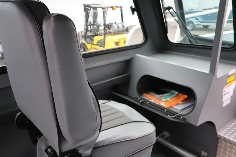 Slide: The Image of Interior of 2026 Alumaweld Horizon 24 boat with gray seating and storage compartment. - 18