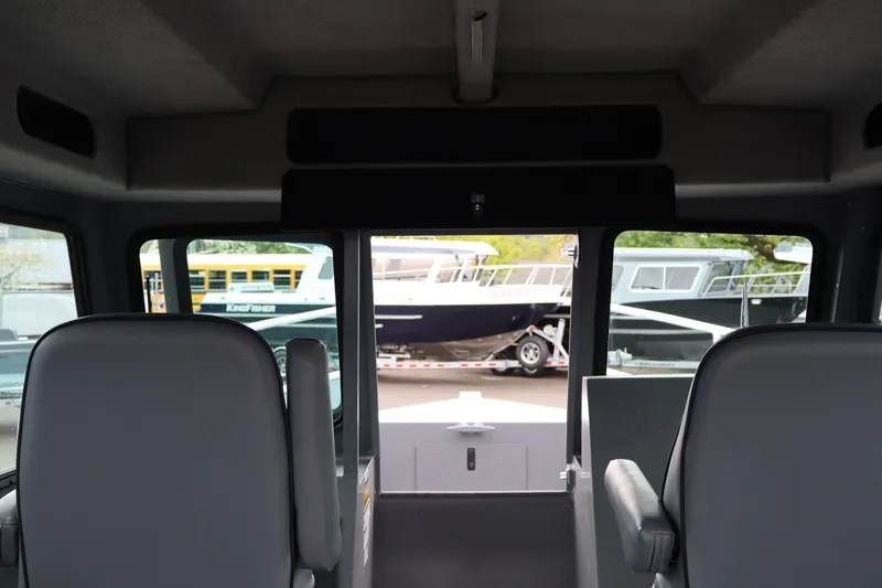 Slide: The Image of Interior view of 2026 Alumaweld Horizon 24 boat with exterior boats visible through windows. - 23