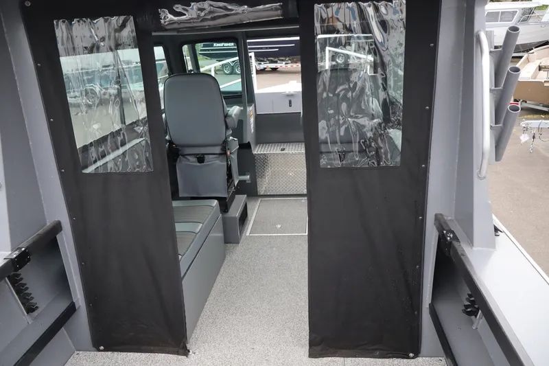 Slide: The Image of Interior view of 2026 Alumaweld Horizon 24 boat with seating and clear vinyl curtains. - 6