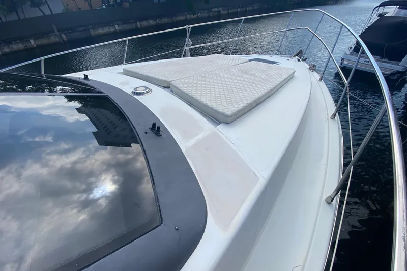Slide: The Image of 1998 Azimut 52 yacht deck with sun pads, docked by the water. - 12