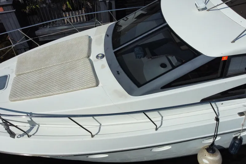 Slide: The Image of 1998 Azimut 52 yacht with sun pads on deck, docked in marina. - 16