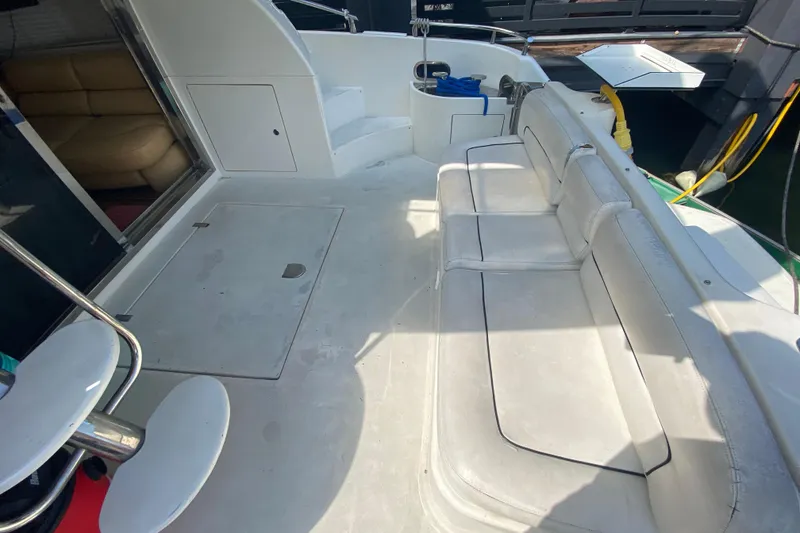 Slide: The Image of 1998 Azimut 52 yacht deck with white seating and interior view. - 23
