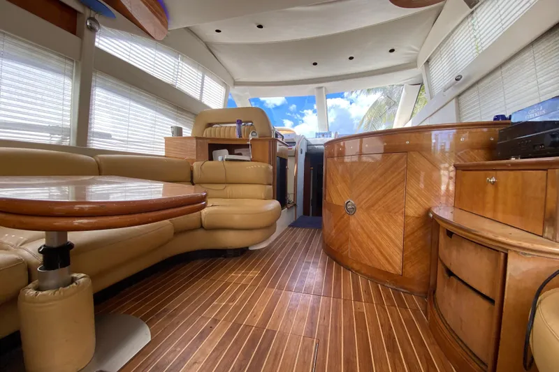 Slide: The Image of Luxurious interior of a 1998 Azimut 52 yacht with elegant wood finishes and leather seating. - 26