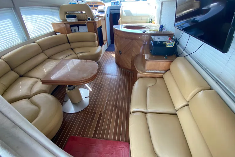 Slide: The Image of Luxurious interior of a 1998 Azimut 52 yacht with beige leather seating and wooden flooring. - 27