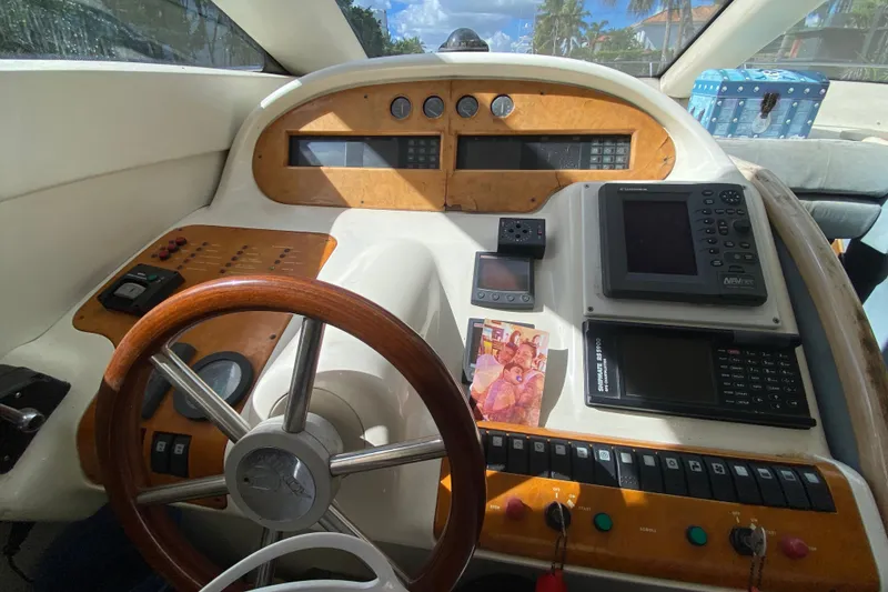 Slide: The Image of Cockpit of a 1998 Azimut 52 yacht with navigation instruments and wooden steering wheel. - 30