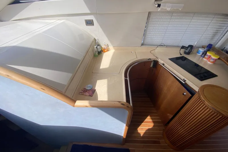 Slide: The Image of 1998 Azimut 52 yacht interior kitchen with wooden cabinetry and modern appliances. - 34