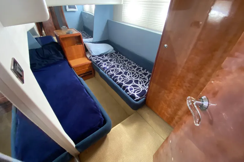 Slide: The Image of Cabin interior of 1998 Azimut 52 yacht with twin beds and wooden accents. - 36