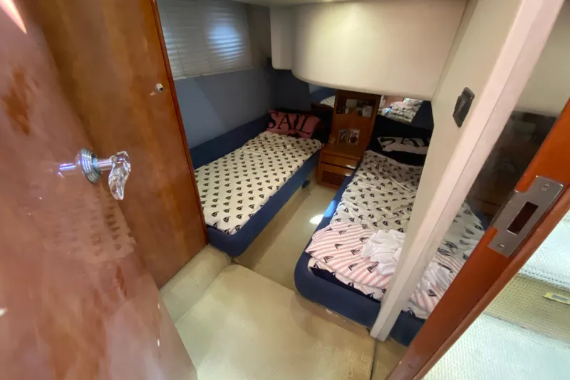 Slide: The Image of Cozy twin cabin interior of 1998 Azimut 52 yacht with nautical-themed bedding. - 38