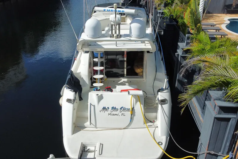 Slide: The Image of 1998 Azimut 52 yacht docked in Miami, Florida, surrounded by lush greenery. - 66