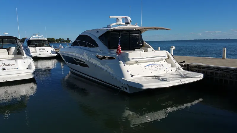 Slide: The Image of 2015 Sea Ray Sundancer 510 yacht docked on a sunny day. - 2