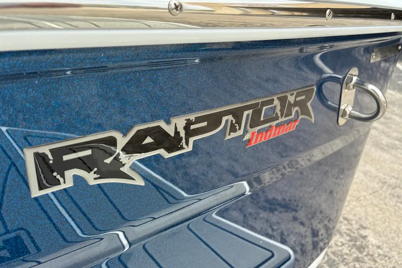 Slide: The Image of 2026 Moomba Tykon boat with Raptor by Indmar engine logo on blue exterior. - 12